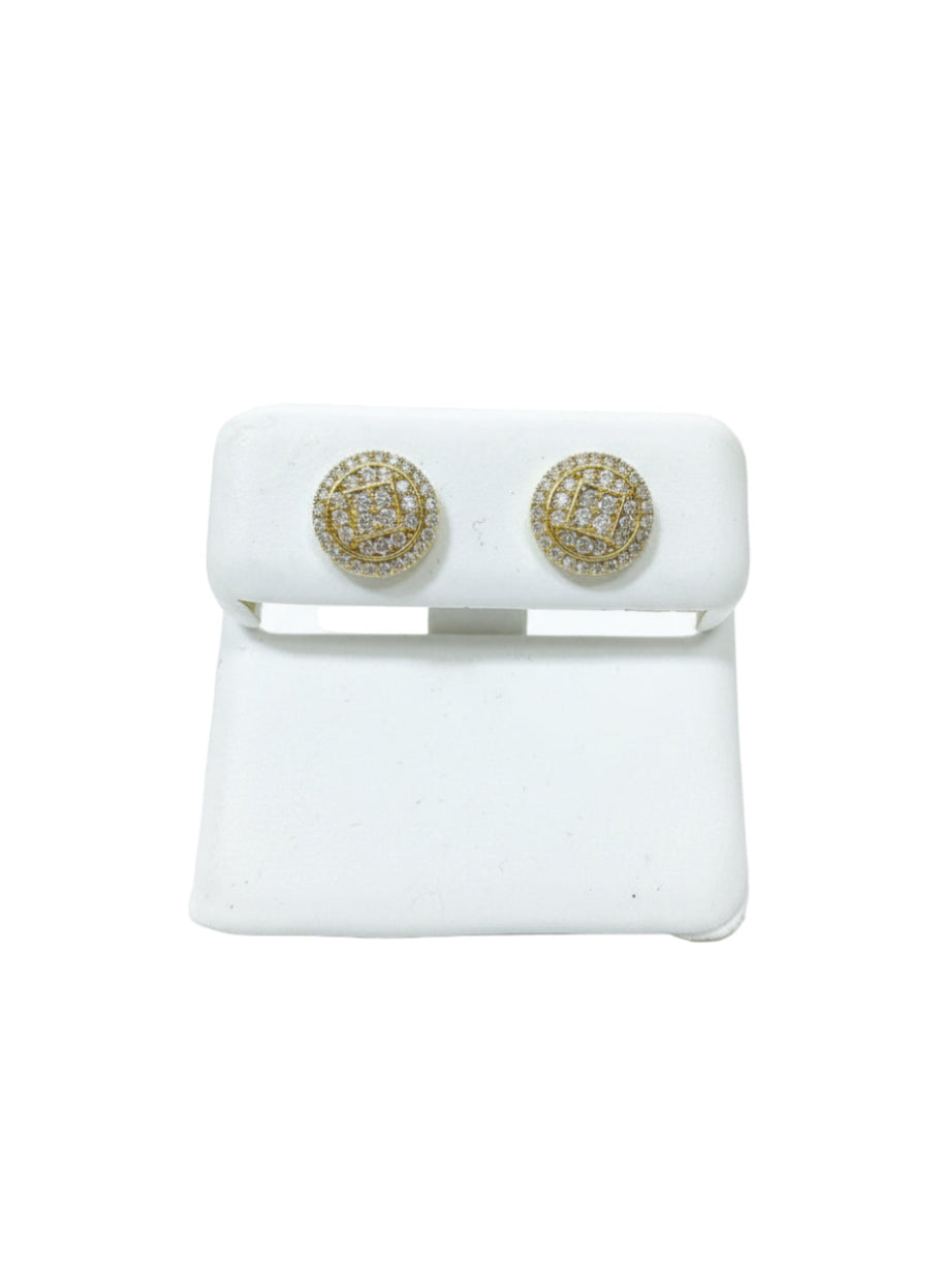 Gold earrings on white stands 